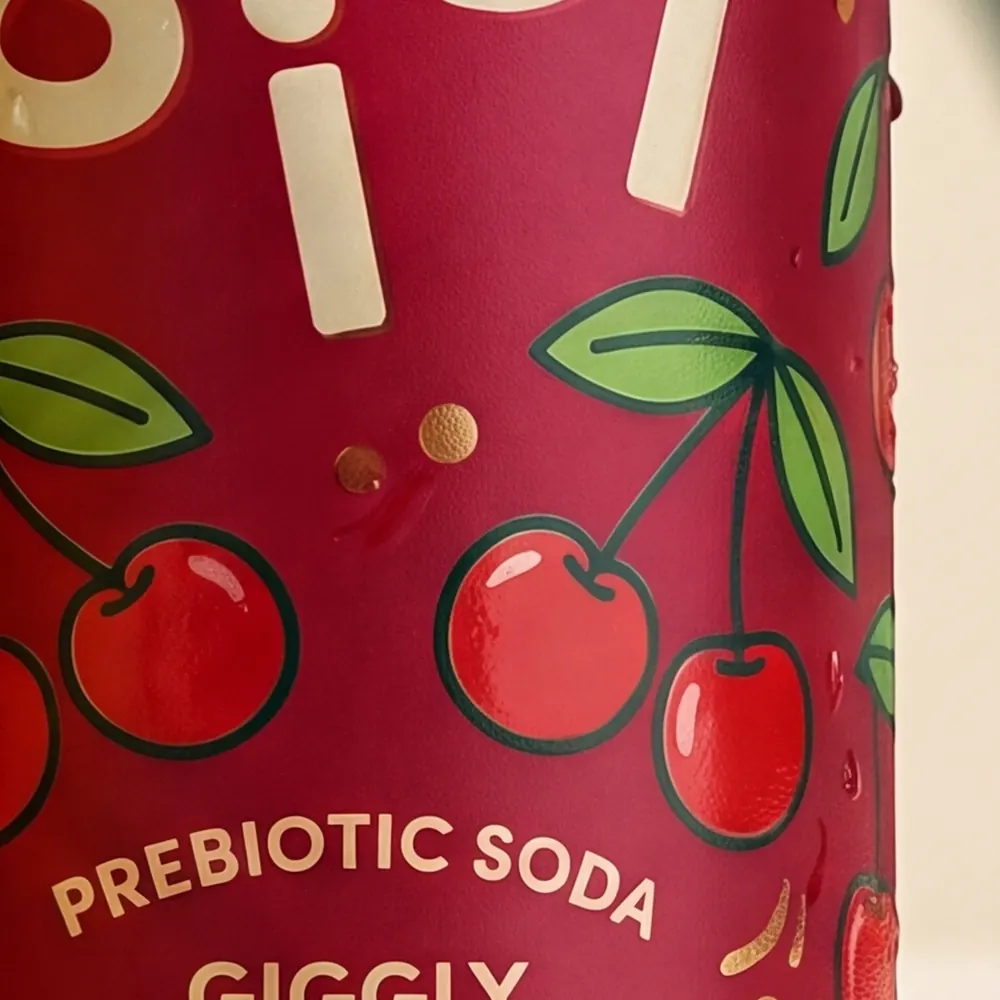 Close-up of the hand-drawn cherry illustration on the Cherry can